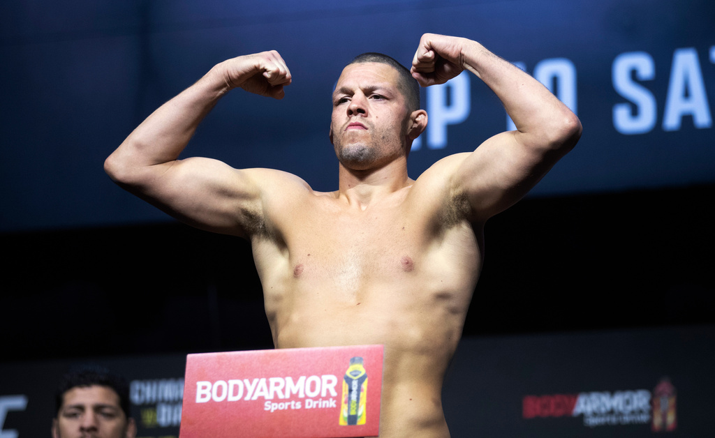 FILE - Nate Diaz poses on the scale during a ceremonial weigh-in for the UFC 279 mixed martial arts event on Sept. 9, 2022, in Las Vegas. (Steve Marcus/Las Vegas Sun via AP, File)