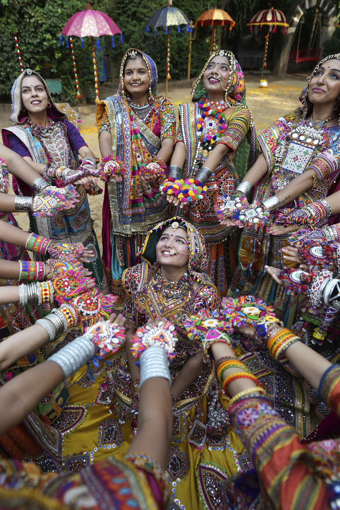 Indians wearing traditional attire pose for the media as they practice the Garba, a traditional dance of Gujarat state, during a rehearsal ahead of Navratri or nine night festival, in Ahmedabad, India, Sept. 15, 2025. (AP Photo/Ajit Solanki)
