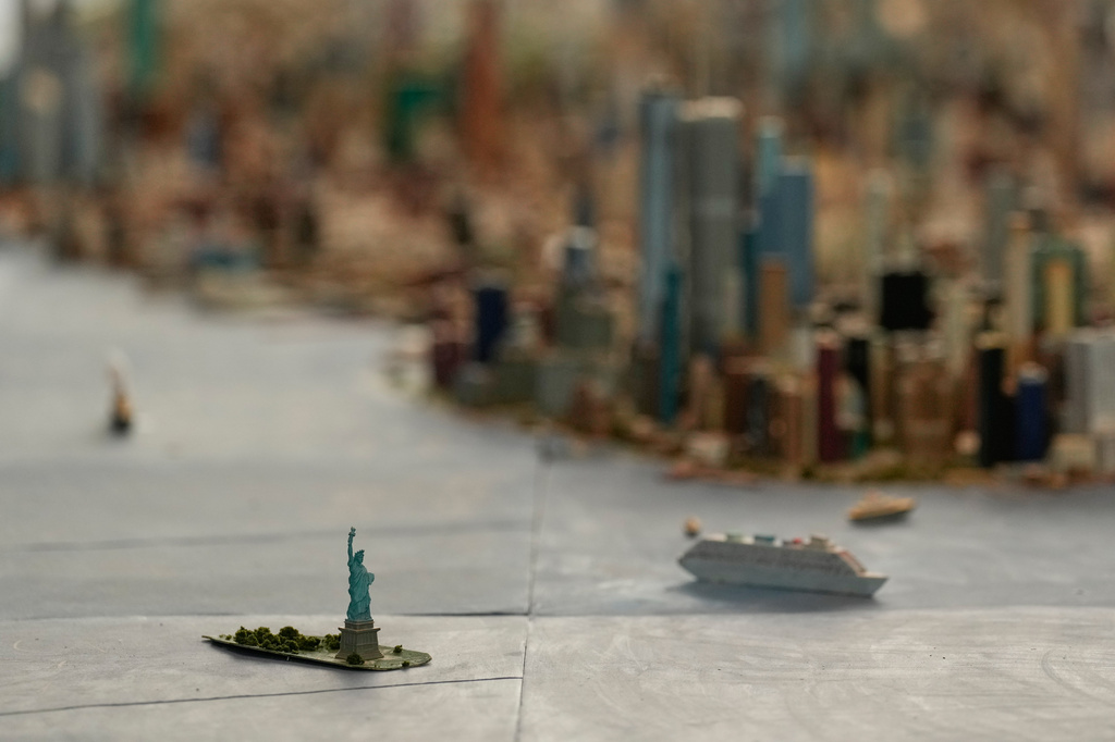 The Statue of Liberty is seen on a large model of the New York City, made by Joe Macken, at the Museum of the City of New York in New York, Monday, Sept. 14, 2026. (AP Photo/Seth Wenig)