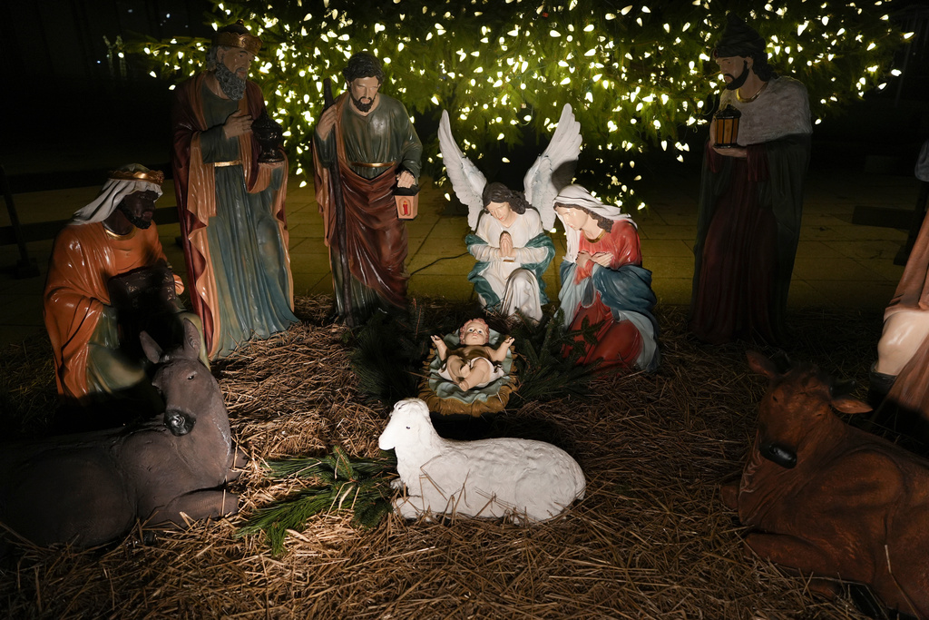 FILE - A Nativity scene is illuminated by a Christmas tree on Payrow Plaza in Bethlehem, Pa., known as "Christmas City, USA," on Sunday, Dec. 1, 2024. (AP Photo/Luis Andres Henao, File)
