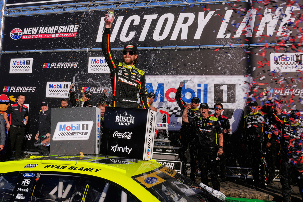 Ryan Blaney, center, celebrates in Victory Lane after winning a NASCAR Cup Series race at New Hampshire Motor Speedway, Sunday, Sept. 21, 2025, in Loudon, N.H. (AP Photo/Charles Krupa)