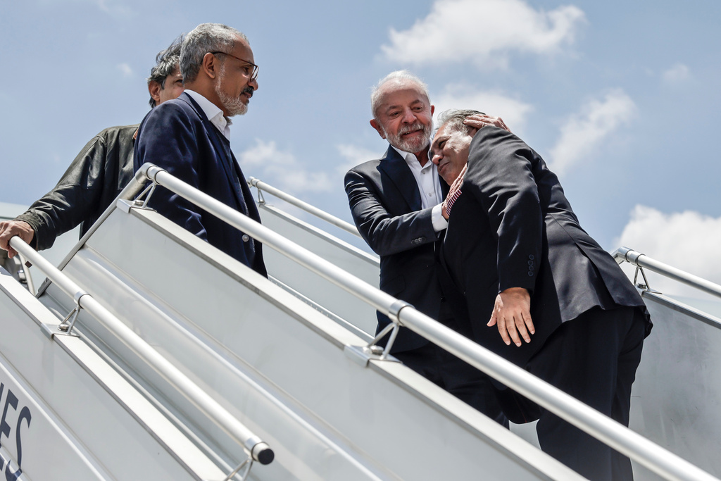 Brazil's President Luiz Inacio Lula da Silva, second right, is welcomed by delegates upon his arrival at the OR Tambo International airport in Ekurhuleni on Friday, Nov. 21, 2025 ahead of the G20 leaders' Summit. ( Marco Longari /Pool Photo via AP)