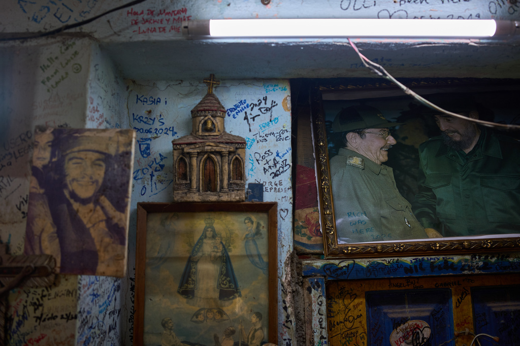 Images of Che Guevara, Virgin of Charity, Raúl Castro, and Fidel Castro hang on a wall in a souvenir shop in Havana, Tuesday, June 2, 2026. (AP Photo/Ramon Espinosa)