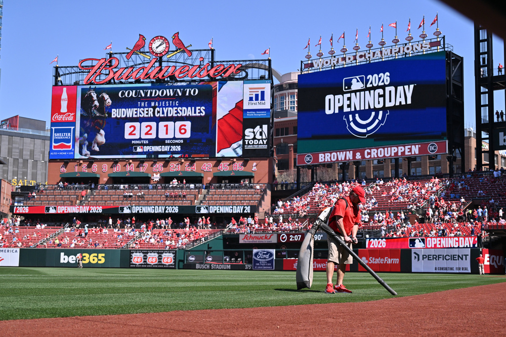 A member of the grounds crew cleans the field prior to an opening-day baseball game between the St. Louis Cardinals and the Tampa Bay Rays, Thursday, March 26, 2026, in St. Louis. (AP Photo/Jeff Le)