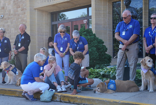 Members of a Lutheran church charities comfort dog ministry sit and stand in front of the Annunciation Catholic Church after Wednesday's school shooting, Thursday, Aug. 28, 2025, in Minneapolis. (AP Photo/Abbie Parr) Members of a Lutheran church charities comfort dog ministry sit and stand in front of the Annunciation Catholic Church after Wednesday's school shooting, Thursday, Aug. 28, 2025, in Minneapolis. (AP Photo/Abbie Parr)