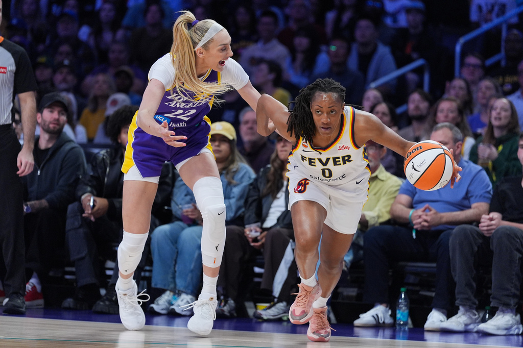 Indiana Fever guard Kelsey Mitchell (0) steals the ball from Los Angeles Sparks forward Cameron Brink (22) during the first half of a WNBA basketball game Wednesday, May 13, 2026, in Los Angeles. (AP Photo/Jae C. Hong)