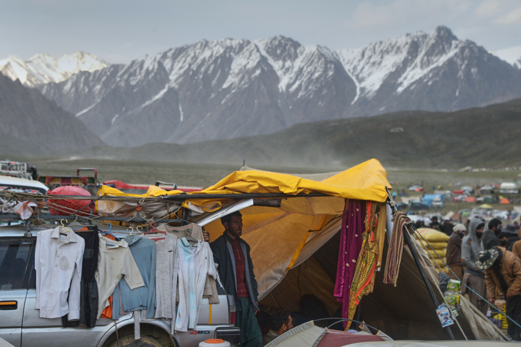 A vendor waits for customers at his used clothes stall in the venue of the three-day annual Shandur Polo Festival in Shandur Pass, in the Ghizer district of Gilgit-Baltistan, northern Pakistan, Friday, June 12, 2026. (AP Photo/Zubair Abbasi)