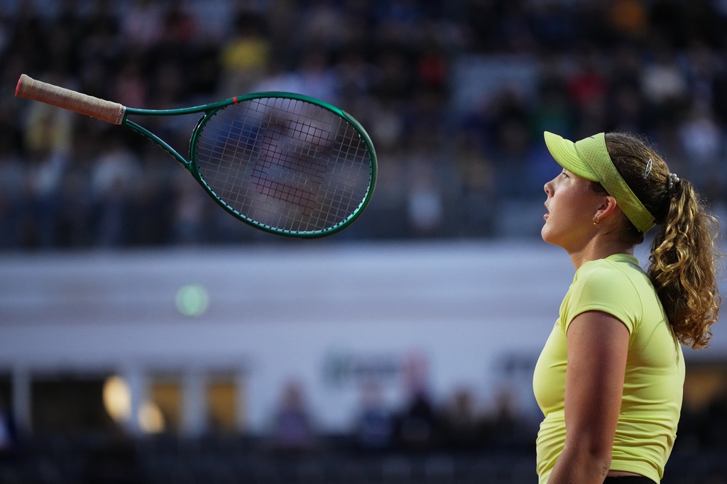 Mirra Andreeva of Russia tosses her racket after losing a point against Coco Gauff of the United States during their match at the Italian Open tennis tournament in Rome, Tuesday, May 12, 2026. (AP Photo/Alessandra Tarantino)