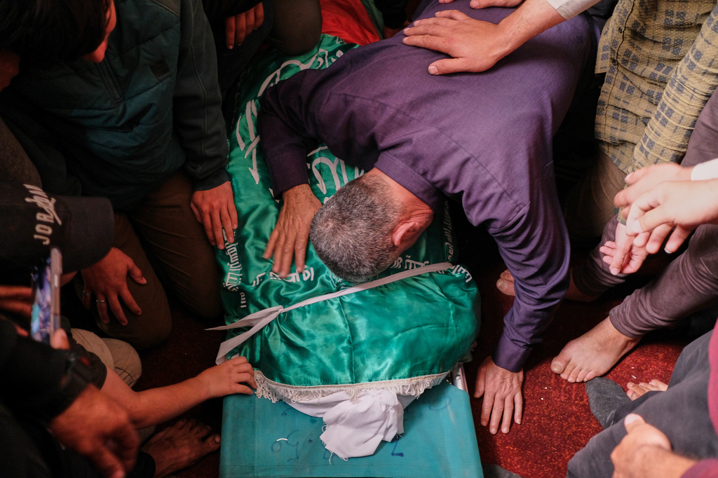 Palestinians mourn over the body of Izz al-Din al-Haddad, the leader of Hamas' Qassam Brigades, during his funeral in Gaza City, Saturday, May 16, 2026. (AP Photo/Jehad Alshrafi)