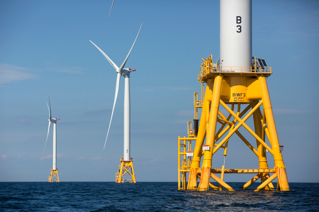 FILE - Three of Deepwater Wind's five turbines stand in the water off Block Island, R.I., Aug. 15, 2016. (AP Photo/Michael Dwyer, File)