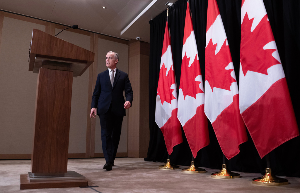 Canada's Prime Minister Mark Carney makes his way to the podium to speak with reporters, in Sydney, Australia, Wednesday, March 4, 2026. (Adrian Wyld/The Canadian Press via AP)