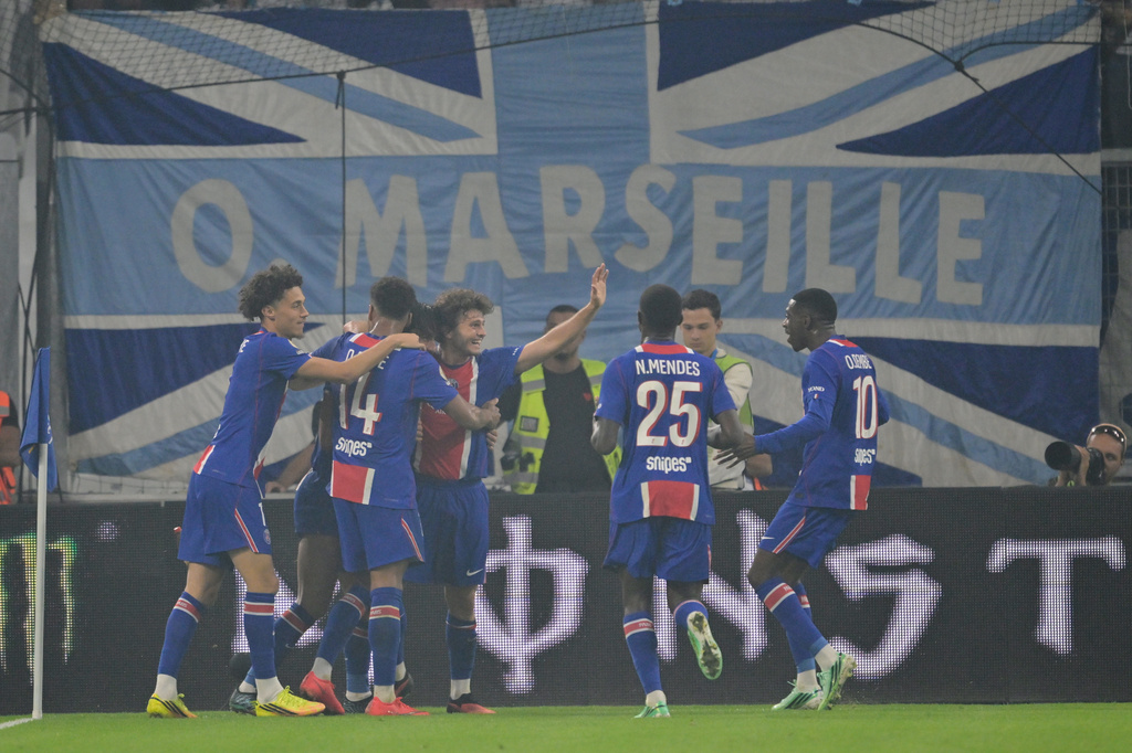 PSG players celebrate after Ferran Torres scored the opening goal during the French League One soccer match between Marseille and Paris Saint-Germain in Marseille, France, Sunday, Sept. 20, 2026. (AP Photo/Philippe Magoni)