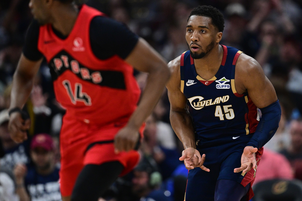 Cleveland Cavaliers guard Donovan Mitchell reacts after making a three point basket during the first half in Game 1 of a first-round NBA playoffs basketball series against the Toronto Raptors, Saturday, April 18, 2026, In Cleveland. (AP Photo/David Dermer)