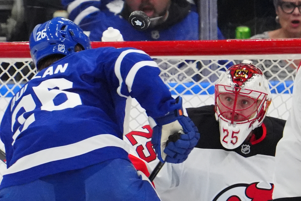 New Jersey Devils goaltender Jacob Markstrom (25) watches the puck as Toronto Maple Leafs' Jacob Quillan skates towards the net during the first period of an NHL hockey game in Toronto, Tuesday Dec. 30, 2025. (Frank Gunn/The Canadian Press via AP)
