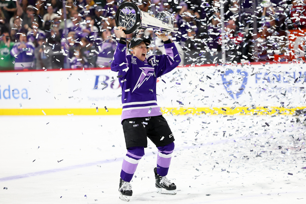 FILE - Minnesota Frost forward Kendall Coyne Schofield celebrates with the Walter Cup after her team won the PWHL hockey finals against the Ottawa Charge, May 26, 2025, in St. Paul, Minn. (AP Photo/Ellen Schmidt, File)