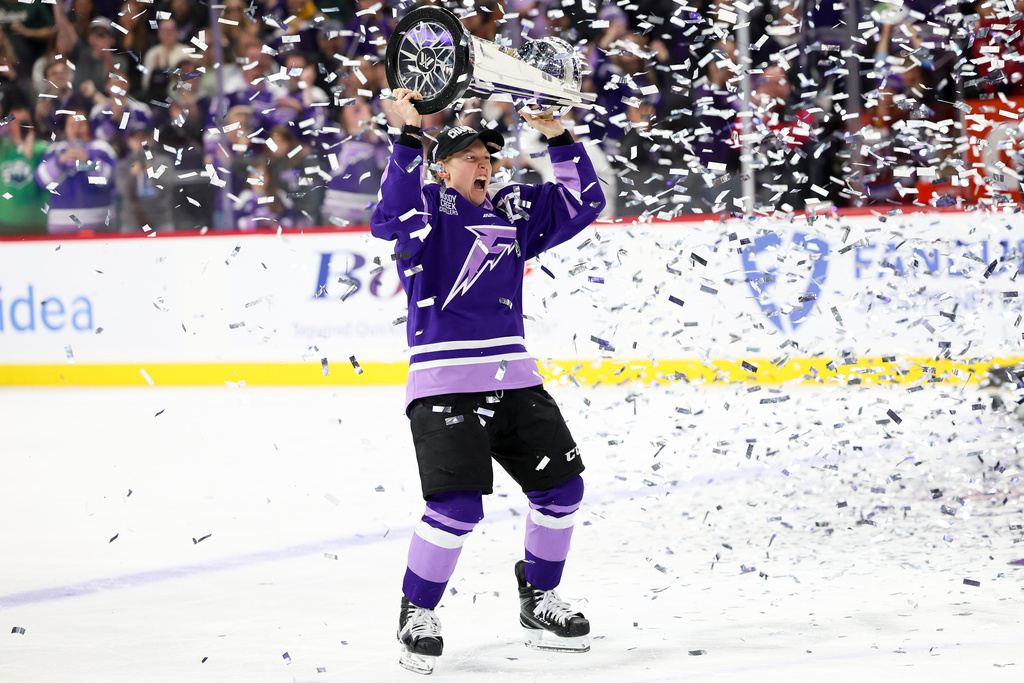 FILE - Minnesota Frost forward Kendall Coyne Schofield celebrates with the Walter Cup after her team won the PWHL hockey finals against the Ottawa Charge, May 26, 2025, in St. Paul, Minn. (AP Photo/Ellen Schmidt, File)