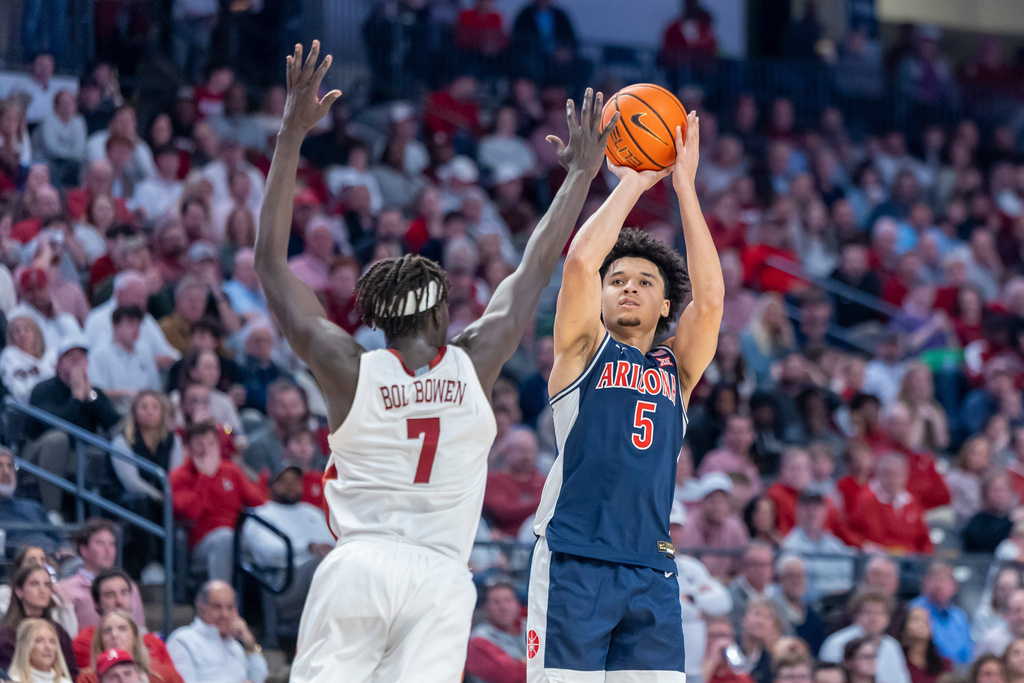 Alabama forward Amari Allen (5) shoots and hits a three-point shot over the defense of Alabama forward Taylor Bol Bowen (7) during the second half of an NCAA college basketball game, Saturday, Dec. 13, 2025, in Birmingham, Ala. (AP Photo/Vasha Hunt)