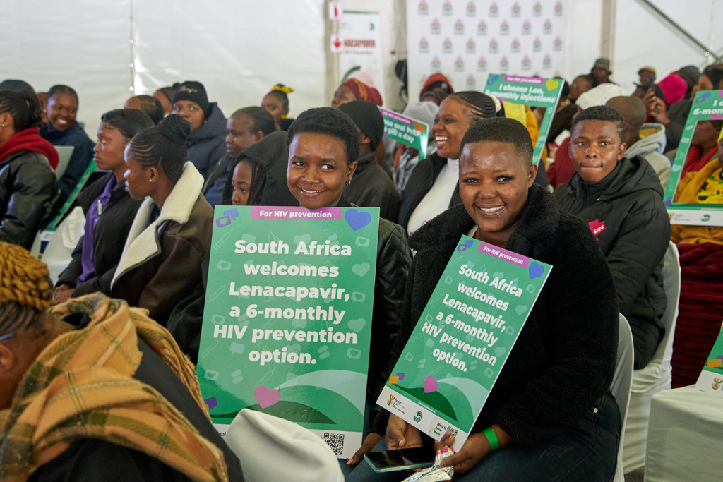 Young people hold posters as they attend the launch of the Lenacapavir rollout programme in Secunda, South Africa, Friday, June 5, 2026. (AP Photo/Kayleen Morgan)
