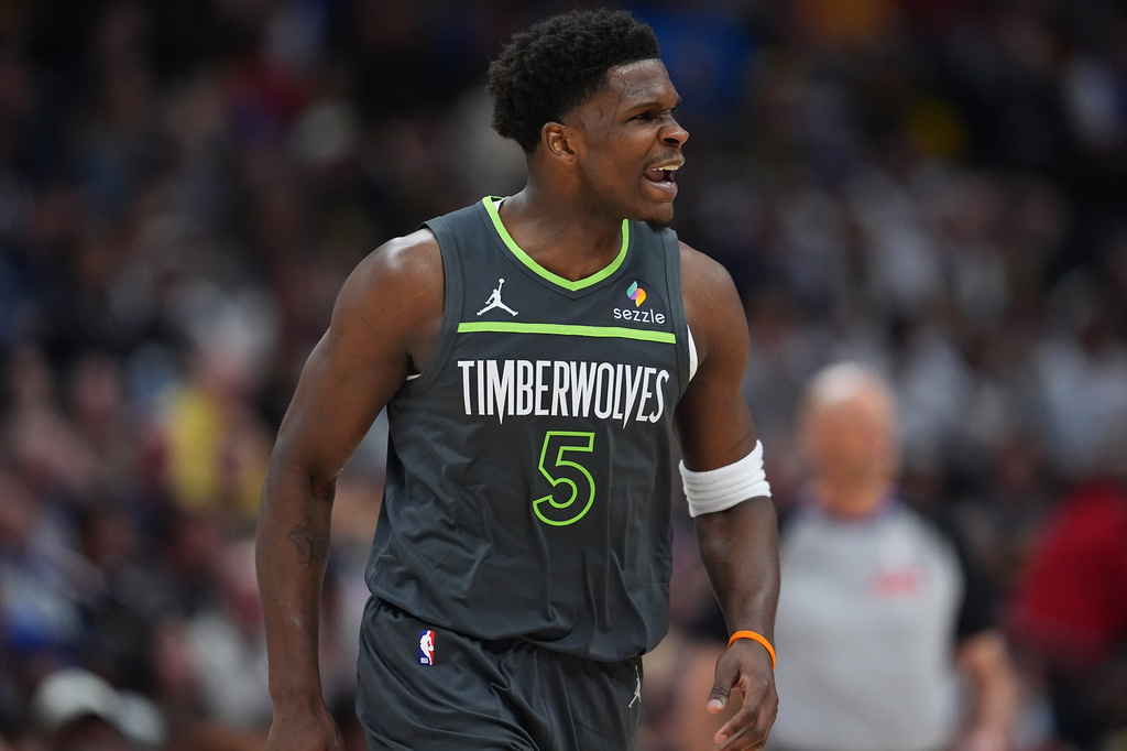 Minnesota Timberwolves guard Anthony Edwards reacts after hitting a 3-point basket against the Denver Nuggets in the first half in Game 1 of a first-round NBA playoffs basketball series, Saturday, April 18, 2026, in Denver. (AP Photo/David Zalubowski)