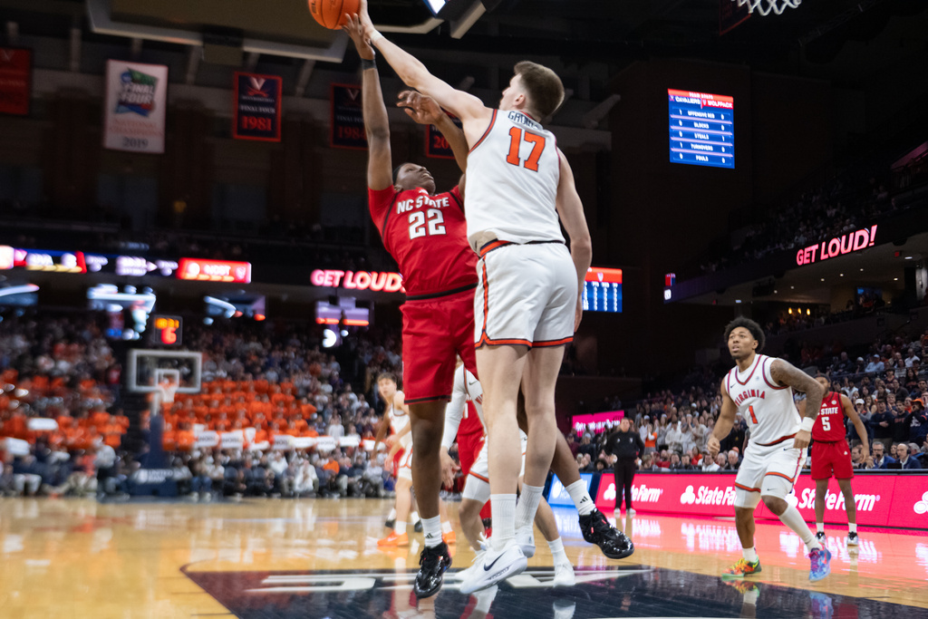 NC State forward Ven-Allen Lubin (22) shot is blocked by Virginia center Johann Grünloh (17) during the first half of an NCAA college basketball game, Tuesday, Feb. 24, 2026, in Charlottesville, Va. (AP Photo/Robert Simmons)