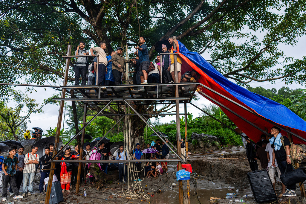 Residents pull the steel wire of a newly installed zipline to help people commute commute across the Trishuli river in the aftermath of flash floods at Bidur in Nepal's Nuwakot district, Nepal, Wednesday, Sept. 2, 2026. (AP Photo/Rajesh Kumar Singh)