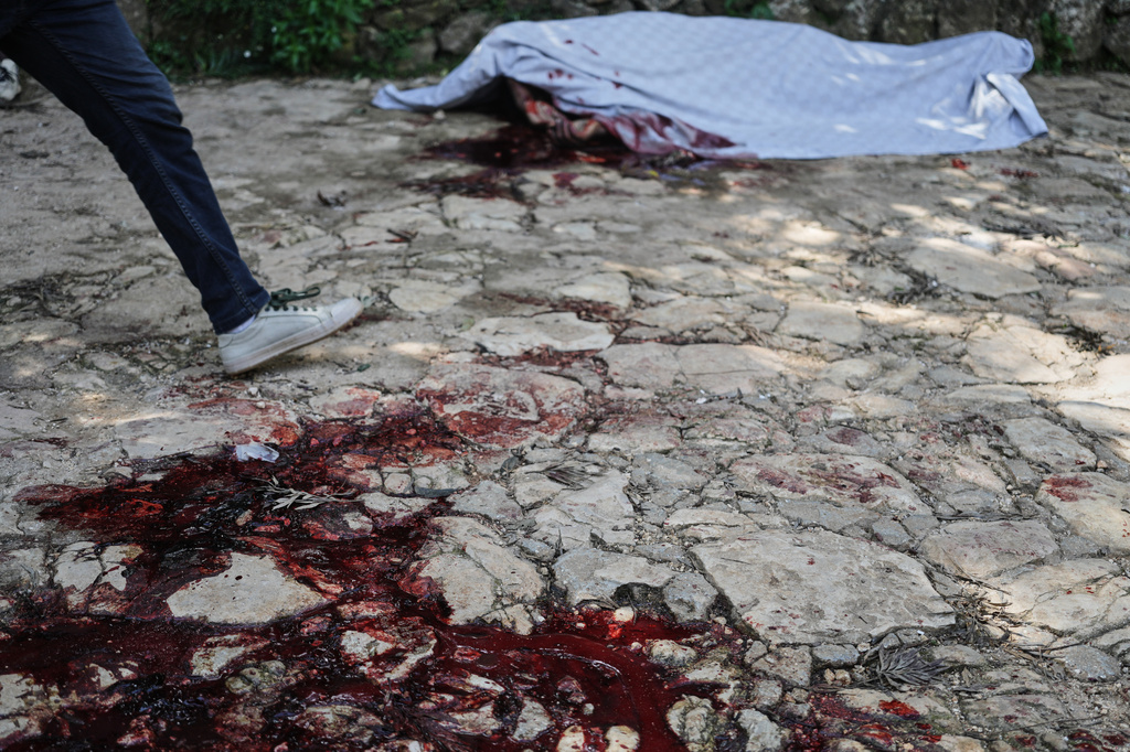 Blood stains the ground left behind by the victim of a gang attack in the Kenscoff neighborhood of Port-au-Prince, Haiti, Monday, Aug. 24, 2026. (AP Photo/Odelyn Joseph)