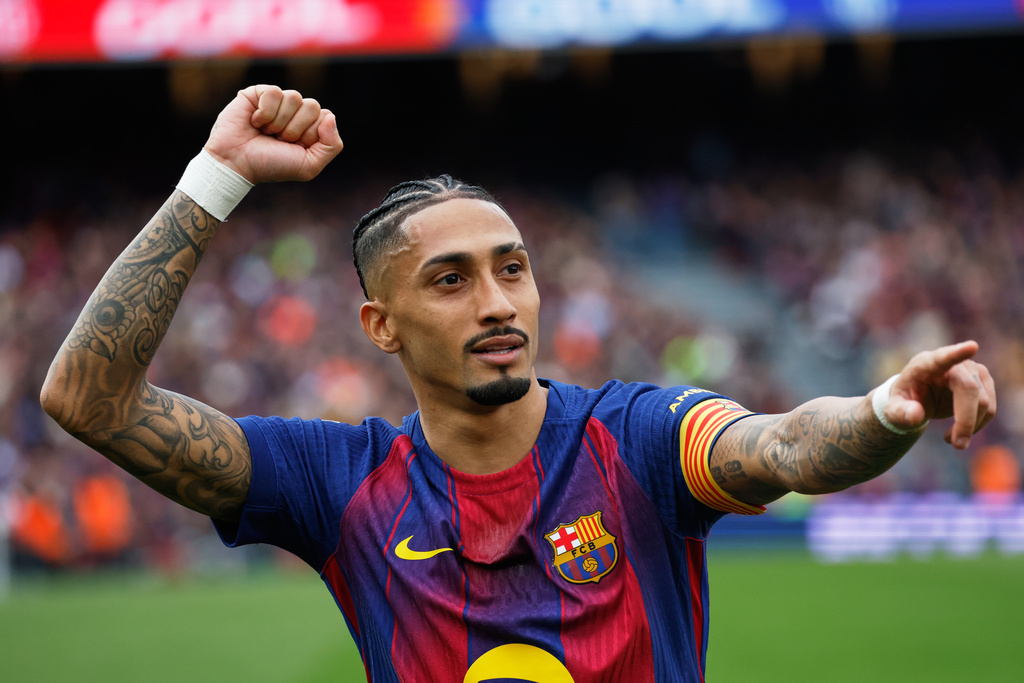 Barcelona's Raphinha celebrates after scoring during the Spanish La Liga soccer match between Barcelona and Sevilla in Barcelona, Spain, Sunday, March 15, 2026. (AP Photo/Joan Monfort)