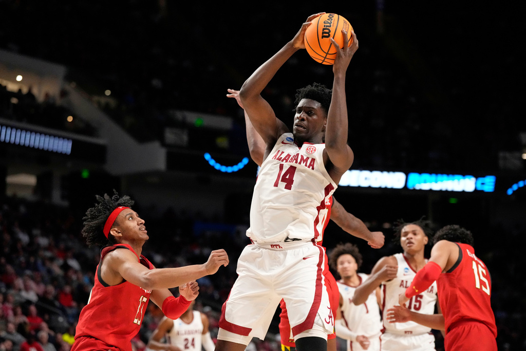 FILE - Alabama center Charles Bediako (14) pulls down a rebound while guarded by Maryland guard Ian Martinez, left, during the second half of a second-round college basketball game in the men's NCAA Tournament in Birmingham, Ala., March 18, 2023. (AP Photo/Rogelio V. Solis, File)