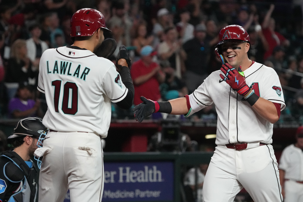 Arizona Diamondbacks' Lars Nootbaar, right, celebrates with center fielder Jordan Lawlar (10) after hitting a two-run home run against the Miami Marlins in the third inning of a baseball game, Monday, Sept 14, 2026, in Phoenix. (AP Photo/Rick Scuteri)