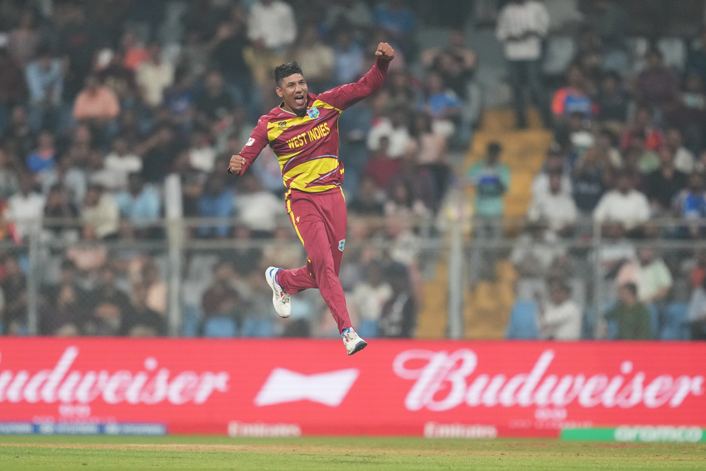 West Indies' Gudakesh Motie celebrates the wicket of Zimbabwe's Tashinga Musekiwa during the T20 World Cup cricket match between Zimbabwe and West Indies in Mumbai, India, Monday, Feb. 23, 2026. (AP Photo/Rafiq Maqbool)