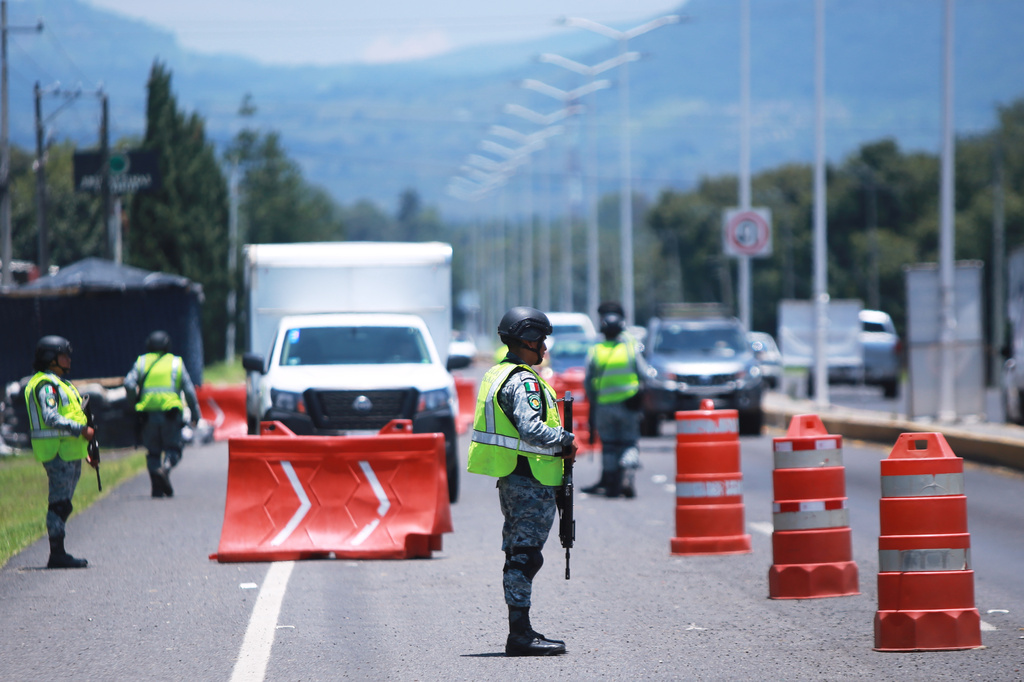 National Guard work at a checkpoint in Cherangueran, Michoacan sate, Mexico, Friday, Aug. 14, 2026. (AP Photo/Armando Solis)