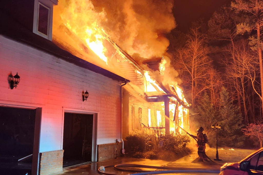 FILE - This photo provided by Lucia-Riverbend Fire Department shows firefighters battling a house fire, Dec. 28, 2025, in Stanley, N.C. (Brian Lee Weyeneth/Lucia-Riverbend Fire Department via AP, File)