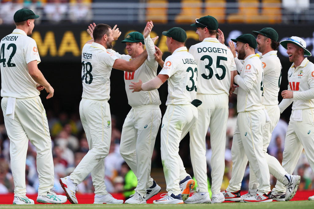 Australia's Michael Neser, second left, celebrates with teammates the wicket of England's Will Jacks during the second Ashes cricket test match between Australia and England in Brisbane, Sunday, Dec. 7, 2025.. (AP Photo/Tertius Pickard)