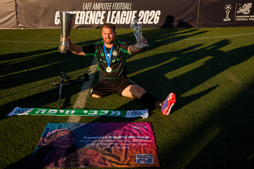 Maccabi Haifa's Ben Binyamin poses with the trophy during the medal ceremony at the end of the amputee soccer inaugural EAFF Conference League in Bucharest, Romania, Friday, Sept. 25, 2026. (AP Photo/Andreea Alexandru)