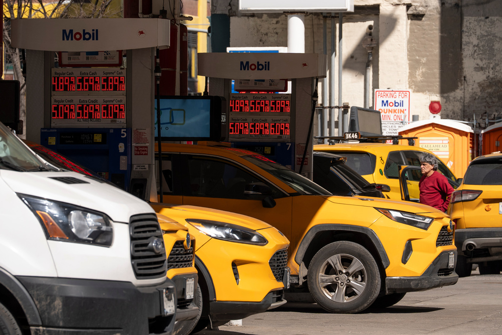 Signs show the gas prices at a gas station, Tuesday, March 10, 2026, in New York. (AP Photo/Yuki Iwamura)