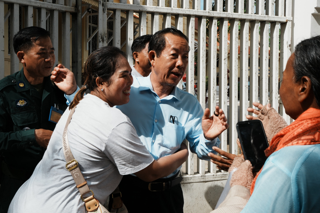 Rong Chhun, a prominent Cambodian opposition politician, center, interacts with his supporters as he leaves a Supreme Court hearing in Phnom Penh, Cambodia, Monday, June 15, 2026. (AP Photo/Heng Sinith)