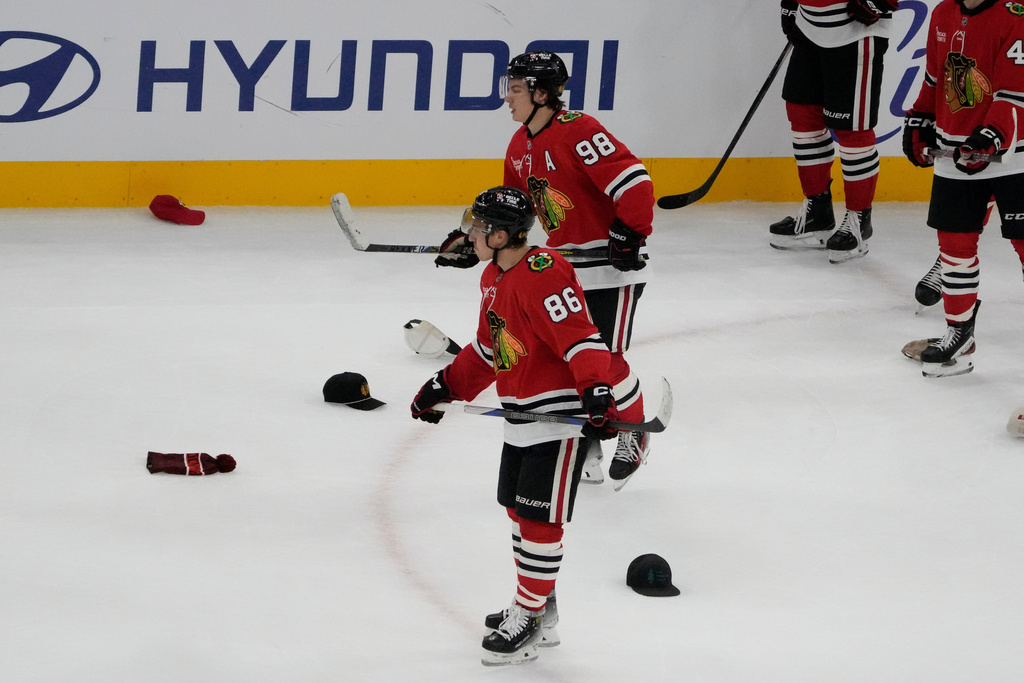 Chicago Blackhawks center Connor Bedard (98) celebrates his hat trick against the Calgary Flames during the third period of an NHL hockey game, Tuesday, Nov. 18, 2025, in Chicago. (AP Photo/David Banks)