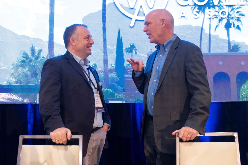 Hawaii Gov. Josh Green and Montana Gov. Greg Gianforte chat during the Western Governors' Association meeting Thursday, Nov. 20, 2025, in Scottsdale, Ariz. (AP Photo/Rebecca Noble)