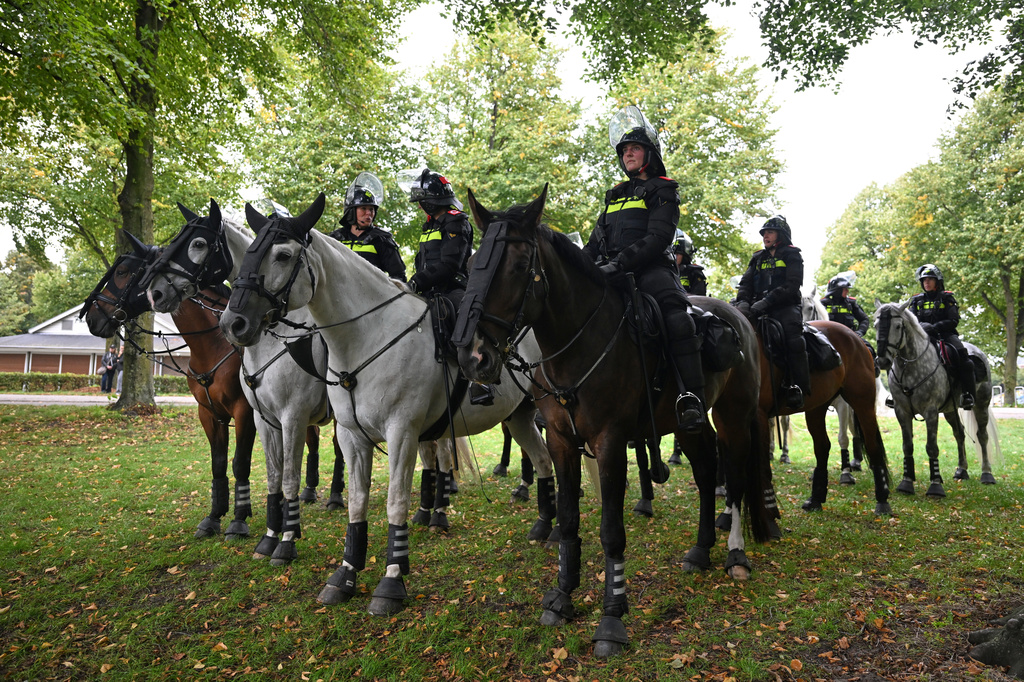 Police officers ride horses during a far-right groups' protest against immigration and asylum policies, in The Hague, Netherlands, Saturday, Sept. 19, 2026. (AP Photo/Mouneb Taim)