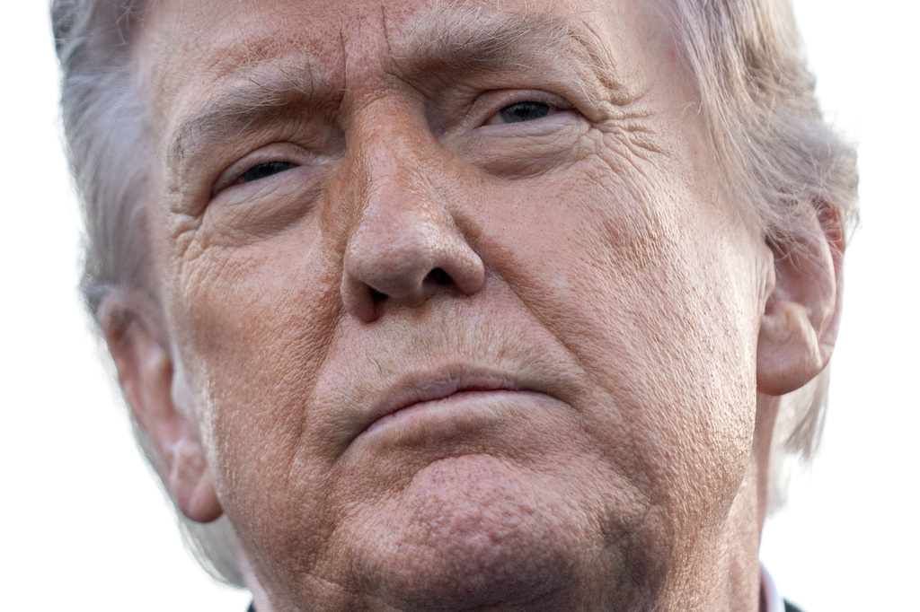 President Donald Trump listens to a reporter's question as he visits the Lincoln Memorial Reflecting Pool to see the new blue protective coating being applied as part of a renovation project, Thursday, May 7, 2026, in Washington. (AP Photo/Mark Schiefelbein)