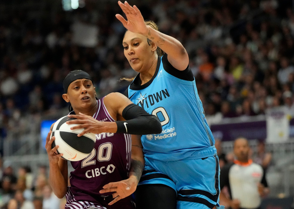 Toronto Tempo guard Brittney Sykes (20) controls the ball as Chicago Sky center Kamilla Cardoso, right, defends during first-half WNBA basketball game action in Toronto, Sunday, June 7, 2026. (Frank Gunn/The Canadian Press via AP)