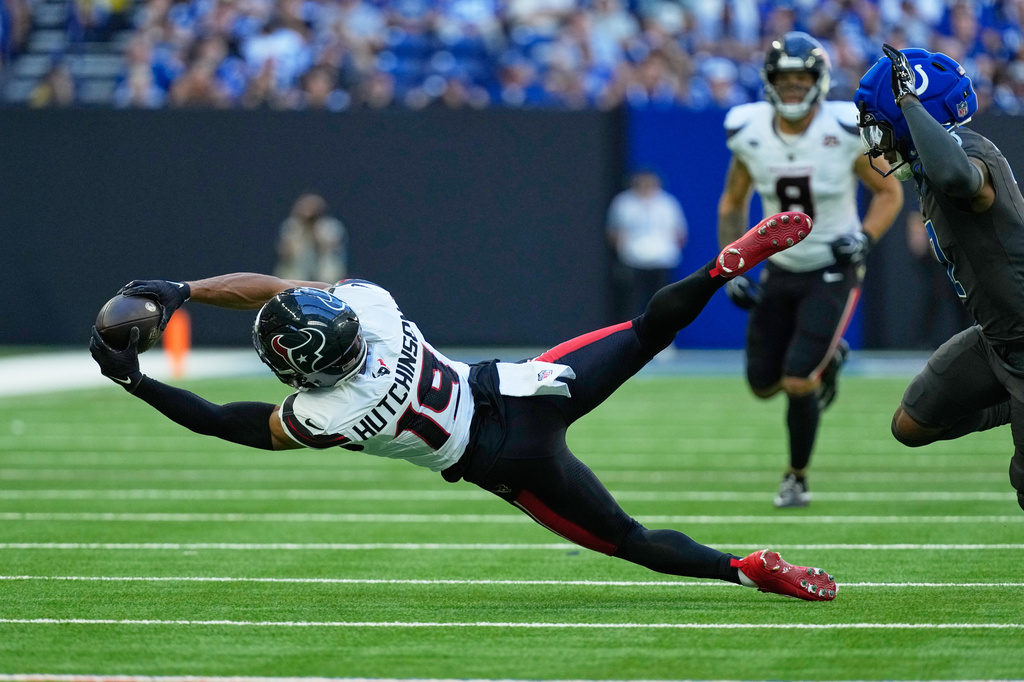 Houston Texans wide receiver Xavier Hutchinson (19) catches a pass as Indianapolis Colts cornerback Charvarius Ward defends during the second half of an NFL football game, Sunday, Sept. 27, 2026, in Indianapolis. (AP Photo/Michael Conroy)