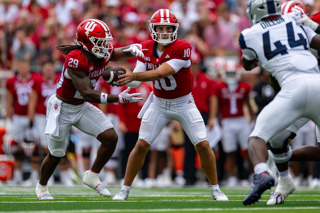 Indiana quarterback Josh Hoover (10) hands the ball off to running back Lee Beebe Jr. (29) during the first half an NCAA college football game against Howard, Saturday, Sept. 12, 2026, in Bloomington, Ind. (AP Photo/Doug McSchooler)