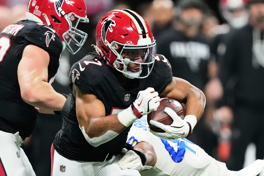 Atlanta Falcons running back Bijan Robinson (7) carries against Los Angeles Rams linebacker Omar Speights (48) in the first half of an NFL football game, Monday, Dec. 29, 2025, in Atlanta. (AP Photo/Brynn Anderson)
