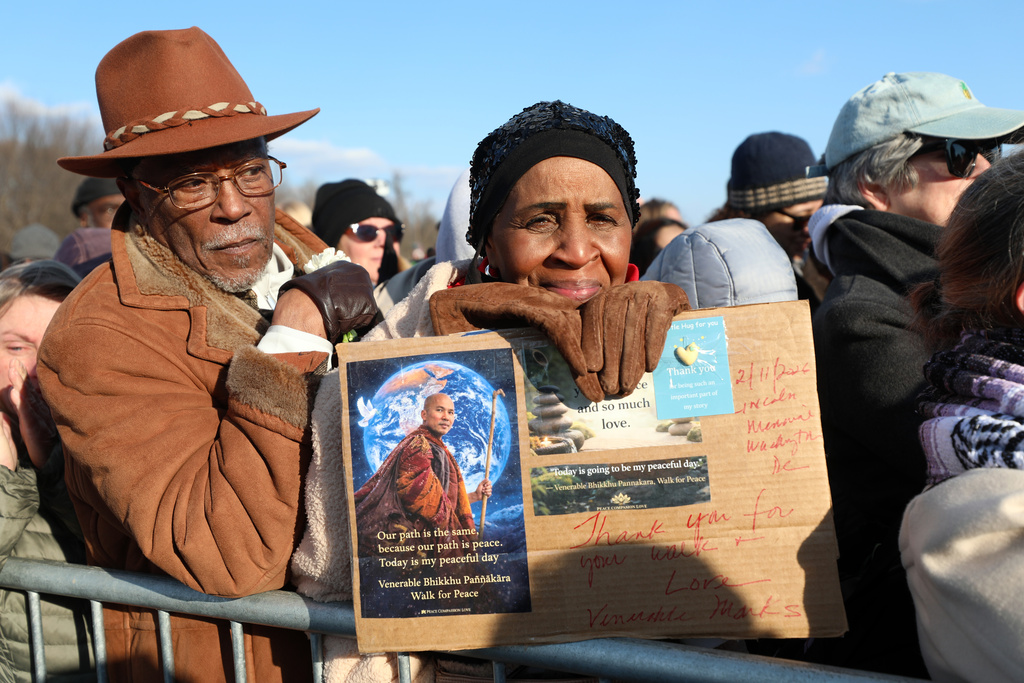People watch at the Lincoln Memorial during the Buddhist monks walk For Peace, Wednesday, Feb. 11, 2026, in Washington. (AP Photo/Rahmat Gul)