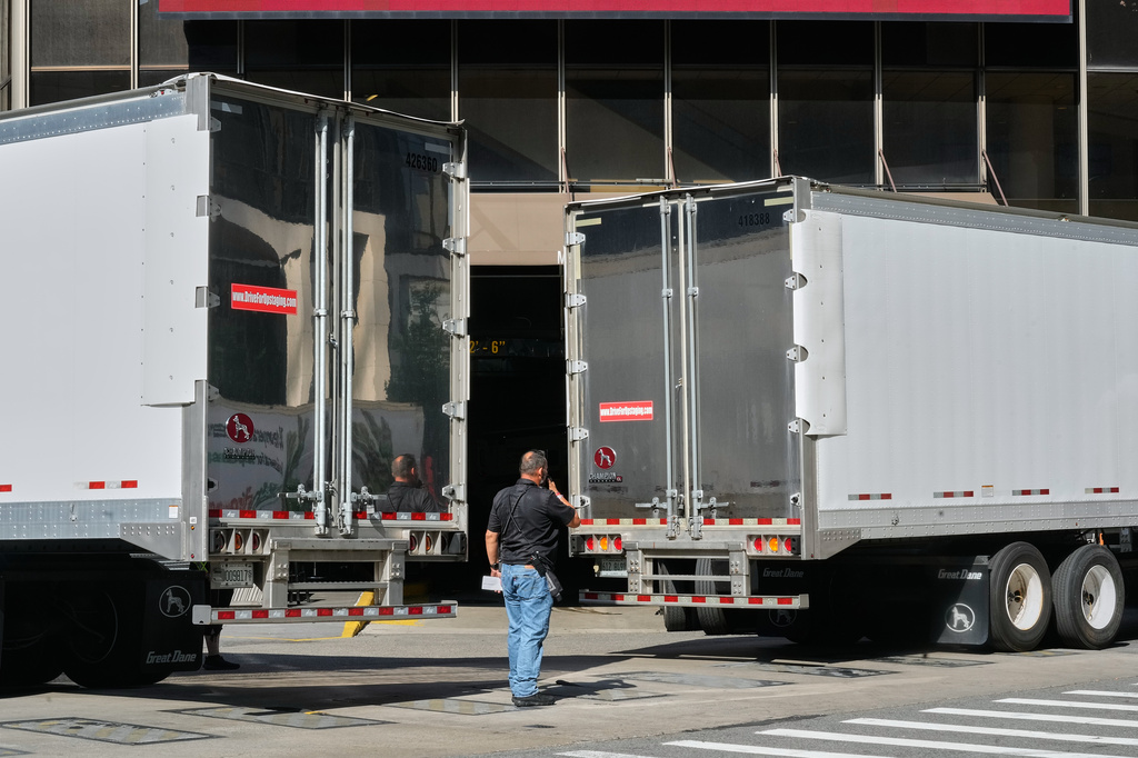 Trucks are moved into position to block photographer's view of the loading dock at New York's Madison Square Garden, Wednesday, July 1, 2026. (AP Photo/Richard Drew)