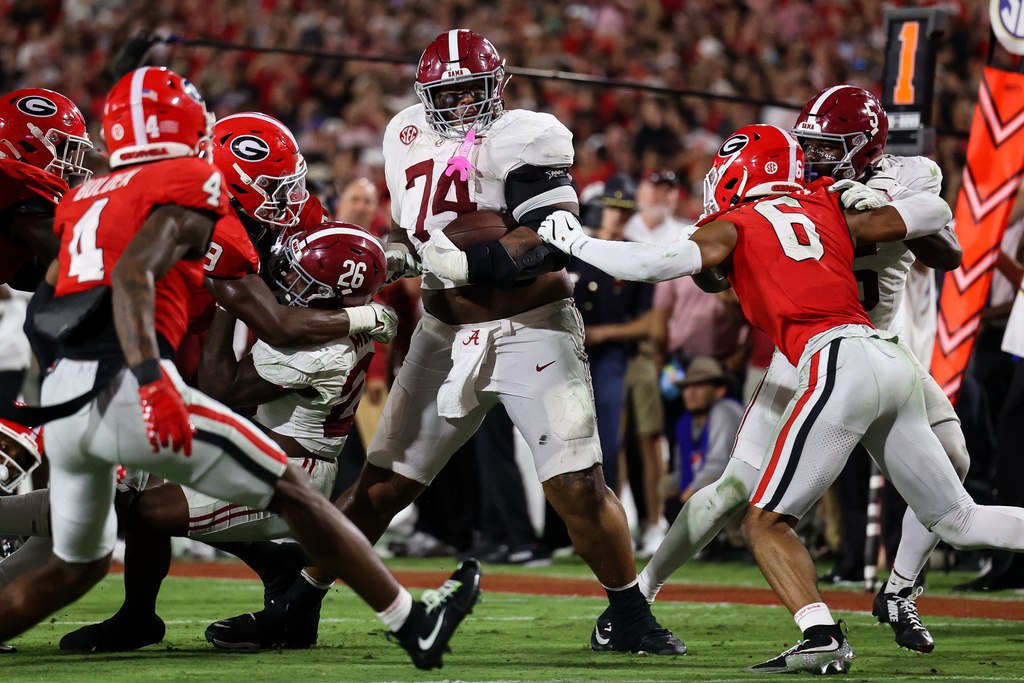 Alabama offensive lineman Kadyn Proctor (74) runs with the football during the first half of an NCAA college football game against Georgia, Saturday, Sept. 27, 2025, in Athens, Ga. (AP Photo/Colin Hubbard)
