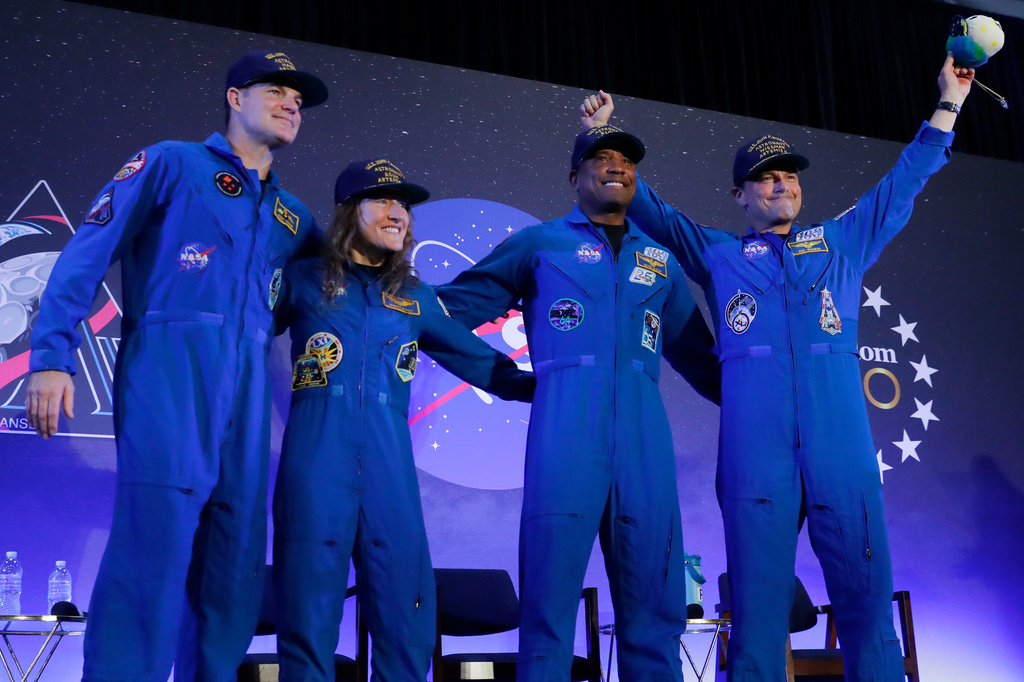 The Artemis II crew, from left, Jeremy Hansen, Christina Koch, Victor Glover and Reid Wiseman come to the center stage at the end of a crew return event Saturday, April 11, 2026, at Ellington Field in Houston. (AP Photo/Michael Wyke)