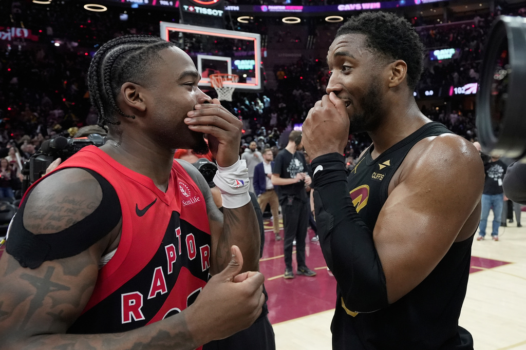 Toronto Raptors guard Jamal Shead, left, and Cleveland Cavaliers guard Donovan Mitchell, right, talk after the Cavaliers defeated the Raptors in Game 7 of a first-round NBA basketball playoffs series in Cleveland, Sunday, May 3, 2026. (AP Photo/Sue Ogrocki)