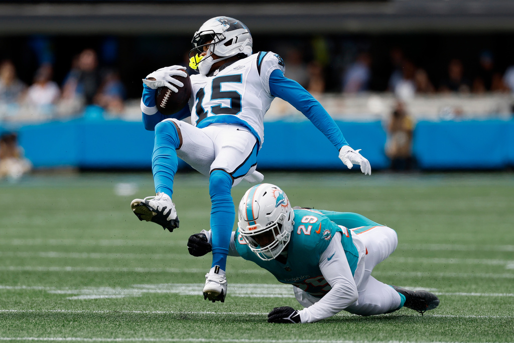 Carolina Panthers wide receiver Jimmy Horn Jr. is tackled by Miami Dolphins free safety Minkah Fitzpatrick during the second half of an NFL football game, Sunday, Oct. 5, 2025, in Charlotte, N.C. (AP Photo/Rusty Jones)
